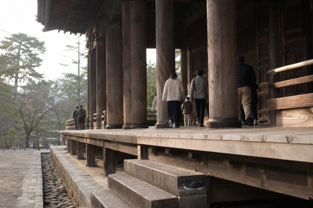 Visitors walking the veranda walkway of the Great Buddha Hall