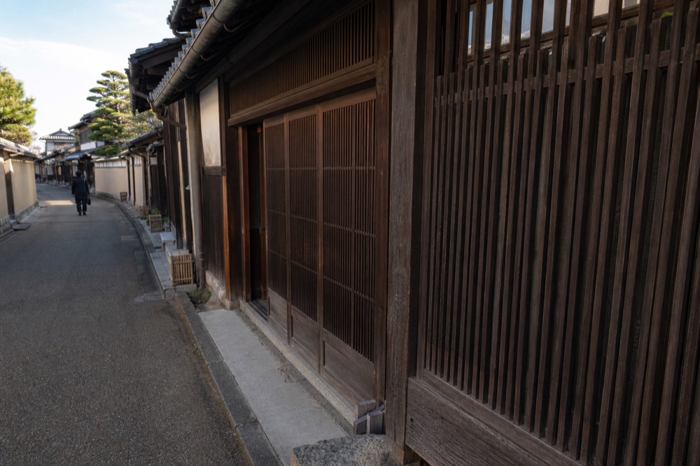 Wooden lattice facade of a narrow traditional townhouse shopfront